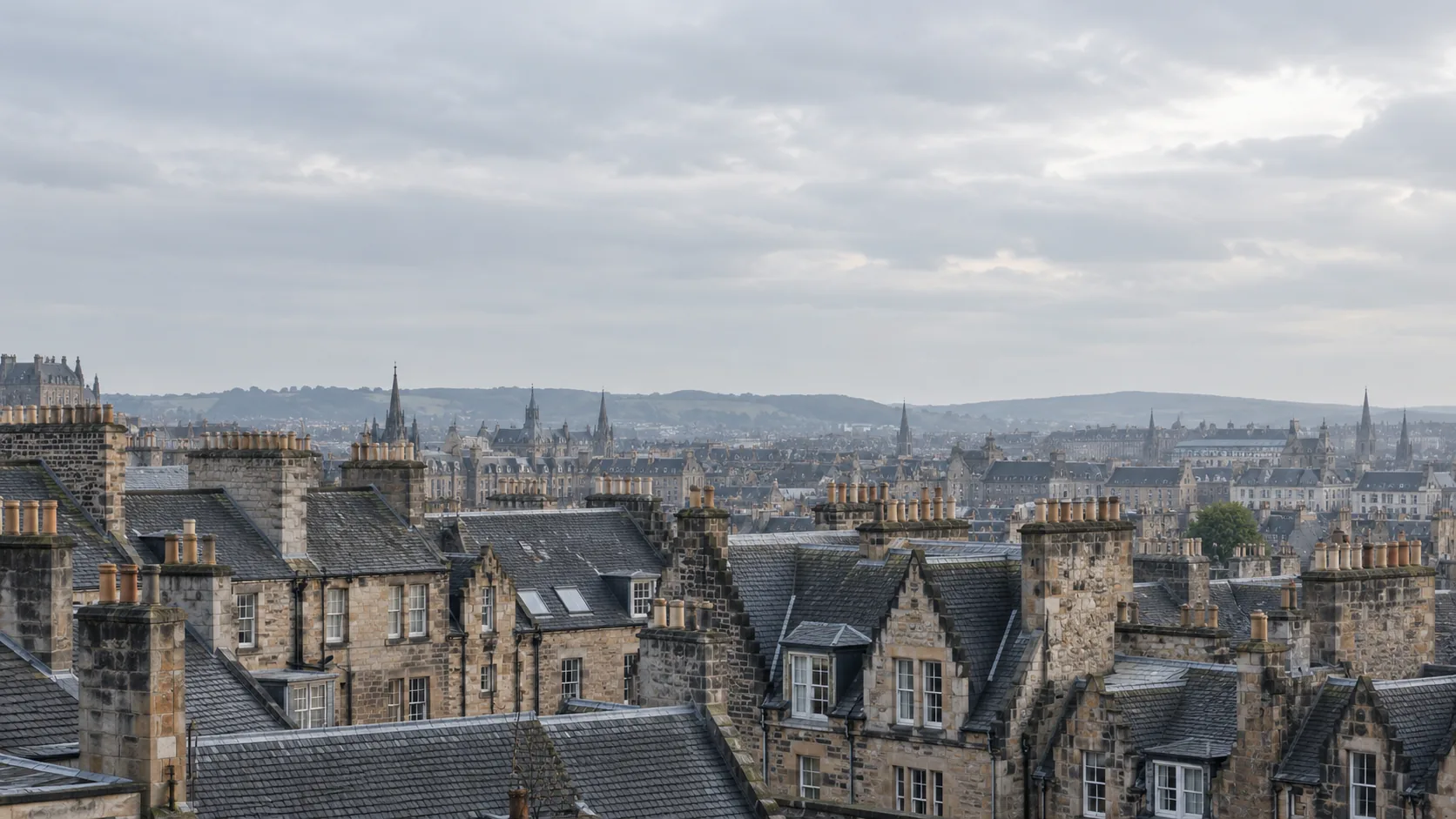 Illustration of Edinburgh tenement rooftops and chimney stacks under an overcast sky